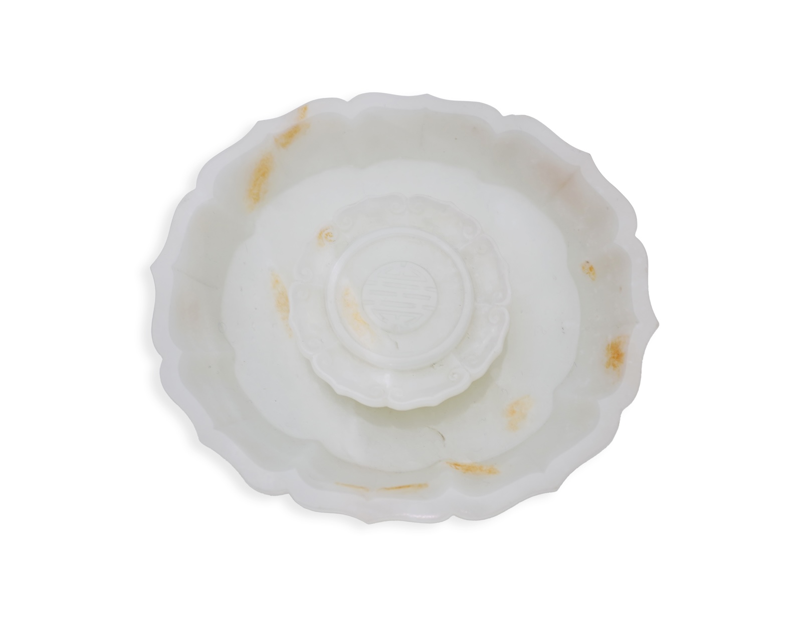 A Chinese white and russet jade petal lobed cup stand